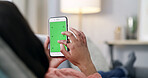Hands, phone and green screen with texting in home, space and relax with scroll on sofa in living room. Person, smartphone and ui with contact, mobile app or streaming on web on couch at apartment