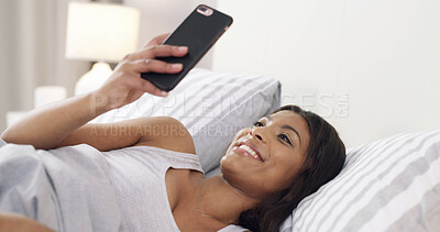 Buy stock photo Happy, woman and texting with smartphone, bedroom and chat on social media, relax and communication. Typing, online and black person with mobile for message, scroll and smile on bed in house or rest