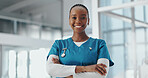 Portrait, nurse and black woman in lobby, arms crossed and smile with confidence, uniform and pride. African person, medical service and professional in clinic, healthcare and career ambition