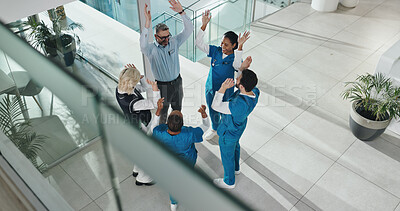Buy stock photo Excited, doctors and people at hospital in circle with partnership for healthcare services. Above team, nurse and surgeon in group huddle with support, collaboration and meeting success at clinic
