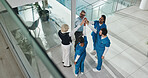 Hands together, doctors and people at hospital in circle with partnership for healthcare services. Above team, nurse and surgeon in group high five with support, collaboration and meeting at clinic