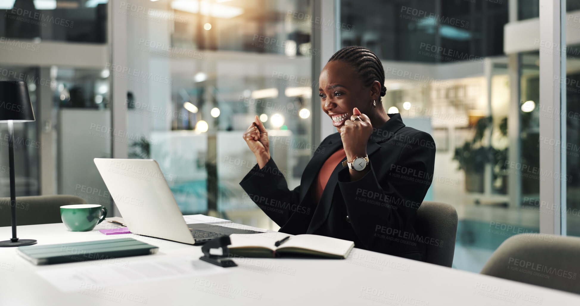 Buy stock photo Fist pump, excited and black woman in office at night with good news, corporate funding or investment. Happy, celebration and African female financial manager with laptop for budget report approval.