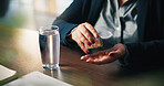 Water, pills and hands of woman in home for medical treatment, prescription and tablets for recovery. House, health and person with medication container for vitamins, supplements and drugs on table
