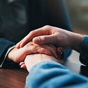 Holding hands, table and couple in home for empathy, support and ...
