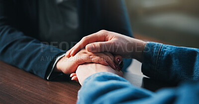 Buy stock photo Holding hands, table and couple in home for empathy, support and bonding for love. Relationship, counseling and above of people together for connection, affection and care for commitment in house