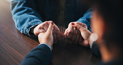 Buy stock photo Holding hands, table and couple in home for comfort, empathy and bonding for love. Relationship, support and closeup of people together for connection, affection and care for commitment in house