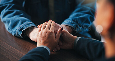 Buy stock photo Holding hands, table and people in office for support, empathy and comforting for therapy. Psychology, counseling and person with patient for connection, trust and care for mental health consulting