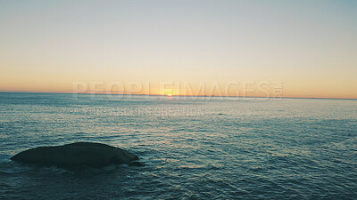 Buy stock photo Sunset, sky and landscape of ocean with rock for holiday destination, travel location and mockup. Space, sea and horizon in natural environment with tropical scenery, beach waves and weekend getaway