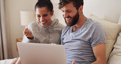 Buy stock photo Couple, laptop and laughing with popcorn on bed for comedy movie, funny series or weekend break. Home, happy people and technology with snacks in bedroom for watching film, relationship or comic show