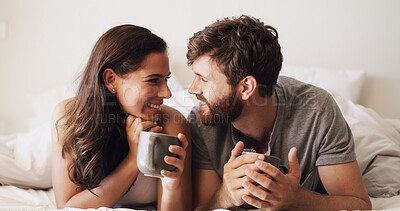 Buy stock photo Couple, relax in bed and coffee with happiness, moment and connection for bonding in home. Woman, man and smile for romance, morning drink and rest with commitment, trust and comfort in bedroom