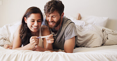 Buy stock photo Smile, love and couple with pregnancy test on bed for future, family or baby together in home. Happy, bonding and man with woman for positive pregnant kit with excitement in marriage in bedroom.
