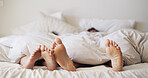 Feet, house and couple sleeping in bedroom for rest, peace and blanket for comfort in morning. Barefoot, people and relax in bed together on mattress with nap, tired and break on weekend in home