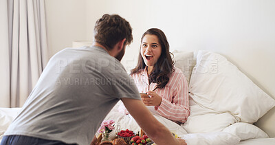 Buy stock photo Surprise, love and couple with breakfast in bed for anniversary, romance or weekend break together. Happy, shocked and man with morning meal for wife in bedroom for marriage celebration in home.