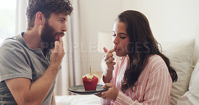 Buy stock photo Bedroom, morning and couple with cupcake, eating and bonding together with care, tasty and snack. Home, frosting and man with woman, treat and romantic with relationship, delicious and dessert