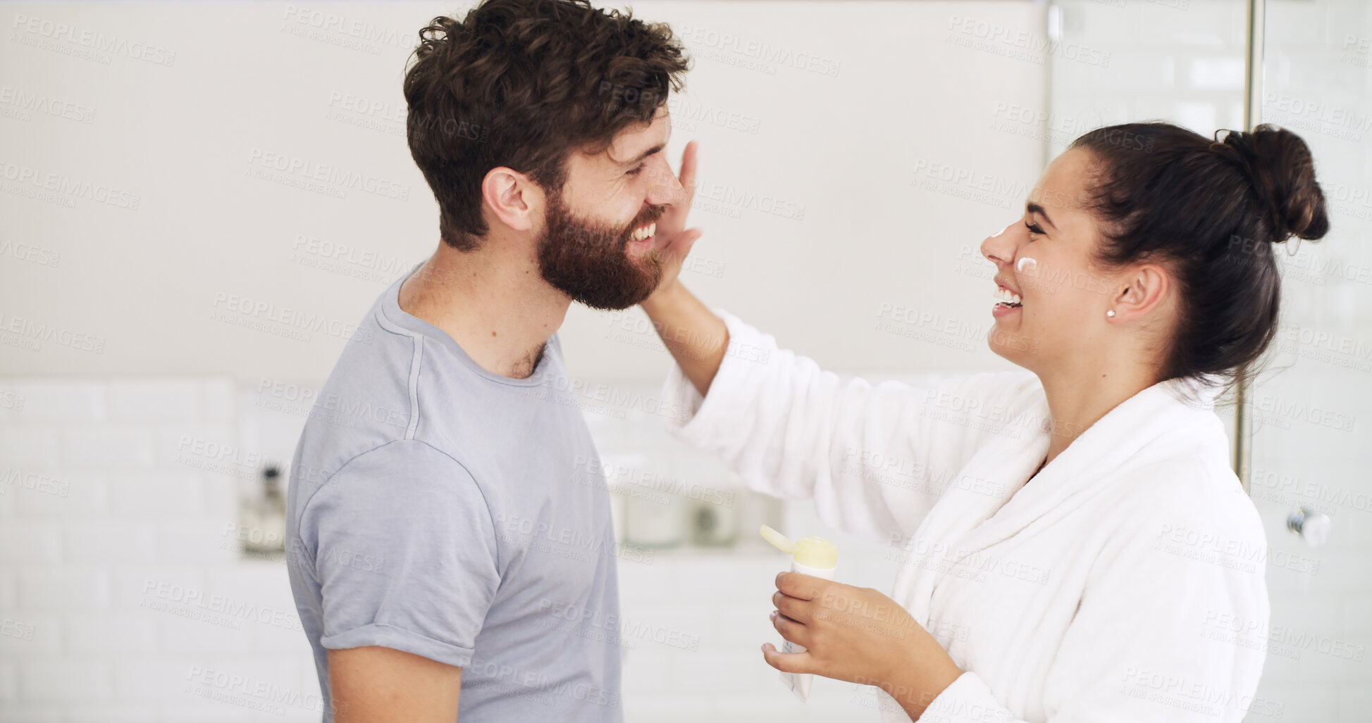 Buy stock photo Skincare, cream and laugh with couple in bathroom for beauty, support and sunscreen protection. Cosmetics, funny and dermatology with man and woman in home for uv lotion, glow and spf product
