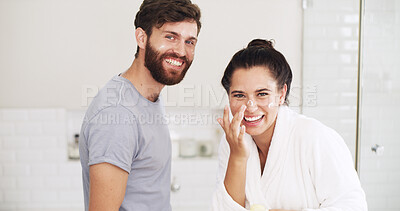 Buy stock photo Cream, portrait and smile with couple in bathroom of home together for moisturizing routine. Beauty, lotion and skincare with happy people laughing in apartment for antiaging cosmetics or wellness