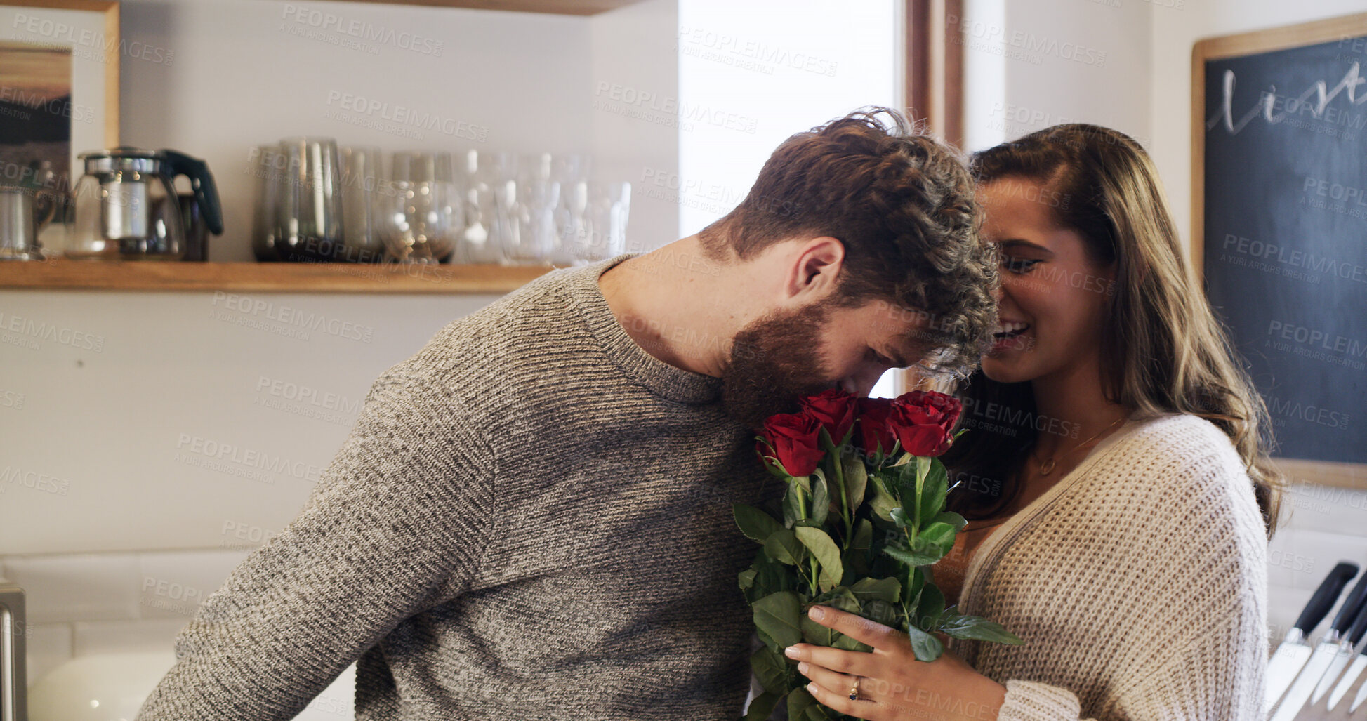 Buy stock photo Flowers, romance and scent with couple in living room of home together for anniversary celebration. Bouquet, gift or smelling roses with man and woman in apartment for aroma, bonding or security