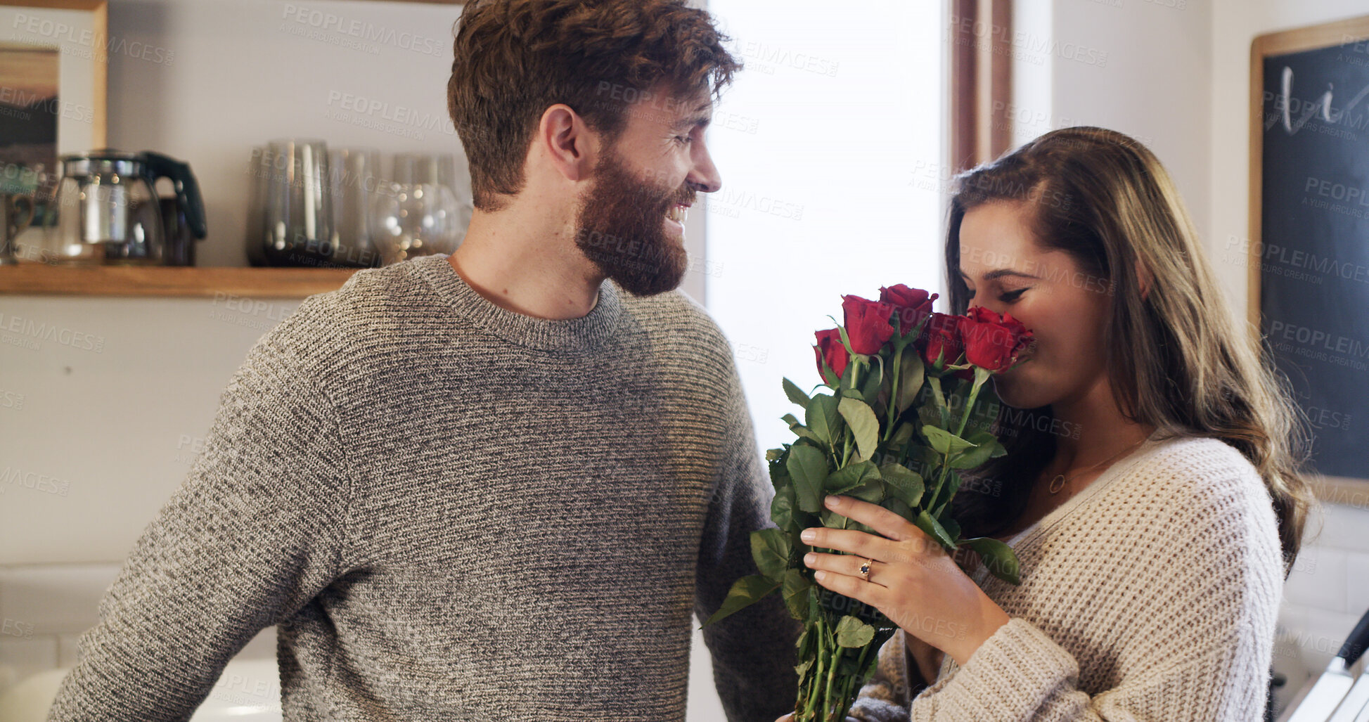 Buy stock photo Man, woman and smell roses in home with gift, surprise and flowers with marriage anniversary in kitchen. Couple, smile and floral bouquet with love, present or celebration for valentines day at house
