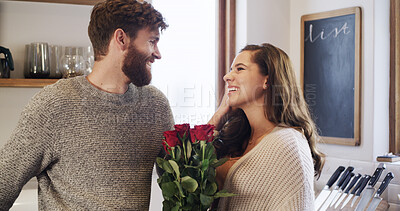 Buy stock photo Celebration, flowers and romance with couple in living room of home together for anniversary moment. Bouquet of roses, gift or smile with man and woman in apartment for bonding, love or security