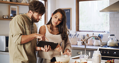 Buy stock photo Couple, tablet and baking in kitchen with help, online tutorial and instructions for recipe. Whisk, man and woman cooking with technology to mix ingredients, info or food guide for meal prep in home