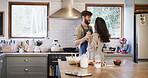 Couple, dance and cooking in kitchen, home and holding hands with love, care or happy for bonding. Man, woman and connection with trust, food and ingredients for healthy nutrition with smile at house