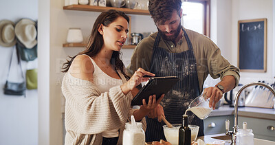 Buy stock photo Couple, tablet and baking in kitchen with milk, online tutorial and instructions for recipe. Home, man and woman cooking with technology to mix ingredients, pour dairy or food guide for meal prep