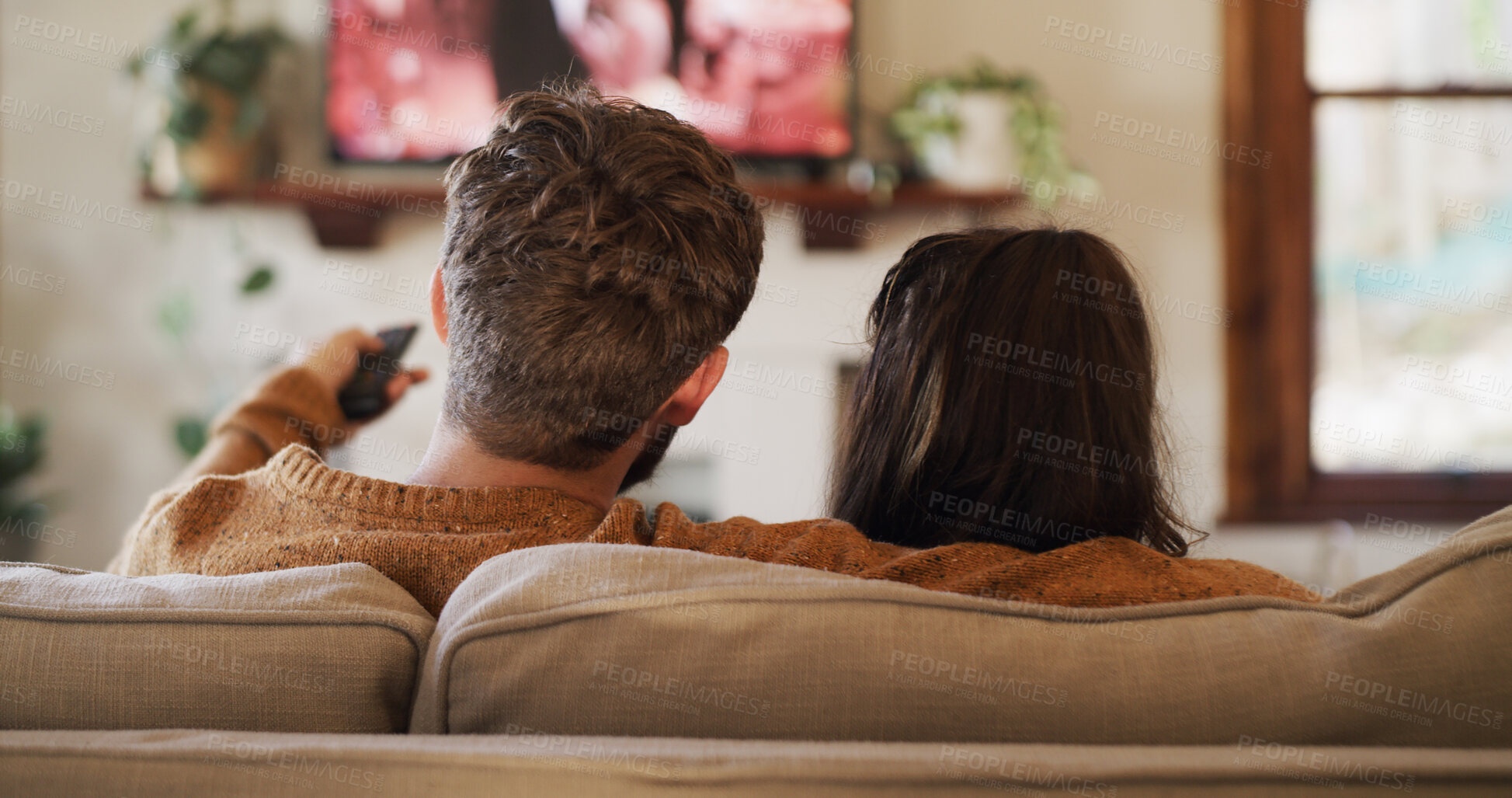 Buy stock photo Back, relax and watching TV with couple on sofa in living room of home for video streaming. Entertainment, movie and television with people in apartment together for bonding, subscription or film