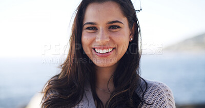 Buy stock photo Happy woman, portrait and relax with fresh air by beach for holiday trip or weekend getaway. Face, female person or tourist with smile for outdoor vacation, travel or destination on ocean coast