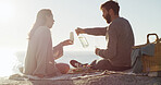 Ocean, picnic and couple with love, champagne and bonding together with holiday, relax and romance. Beach, alcohol and man with woman, anniversary and celebration with vacation, date or relationship