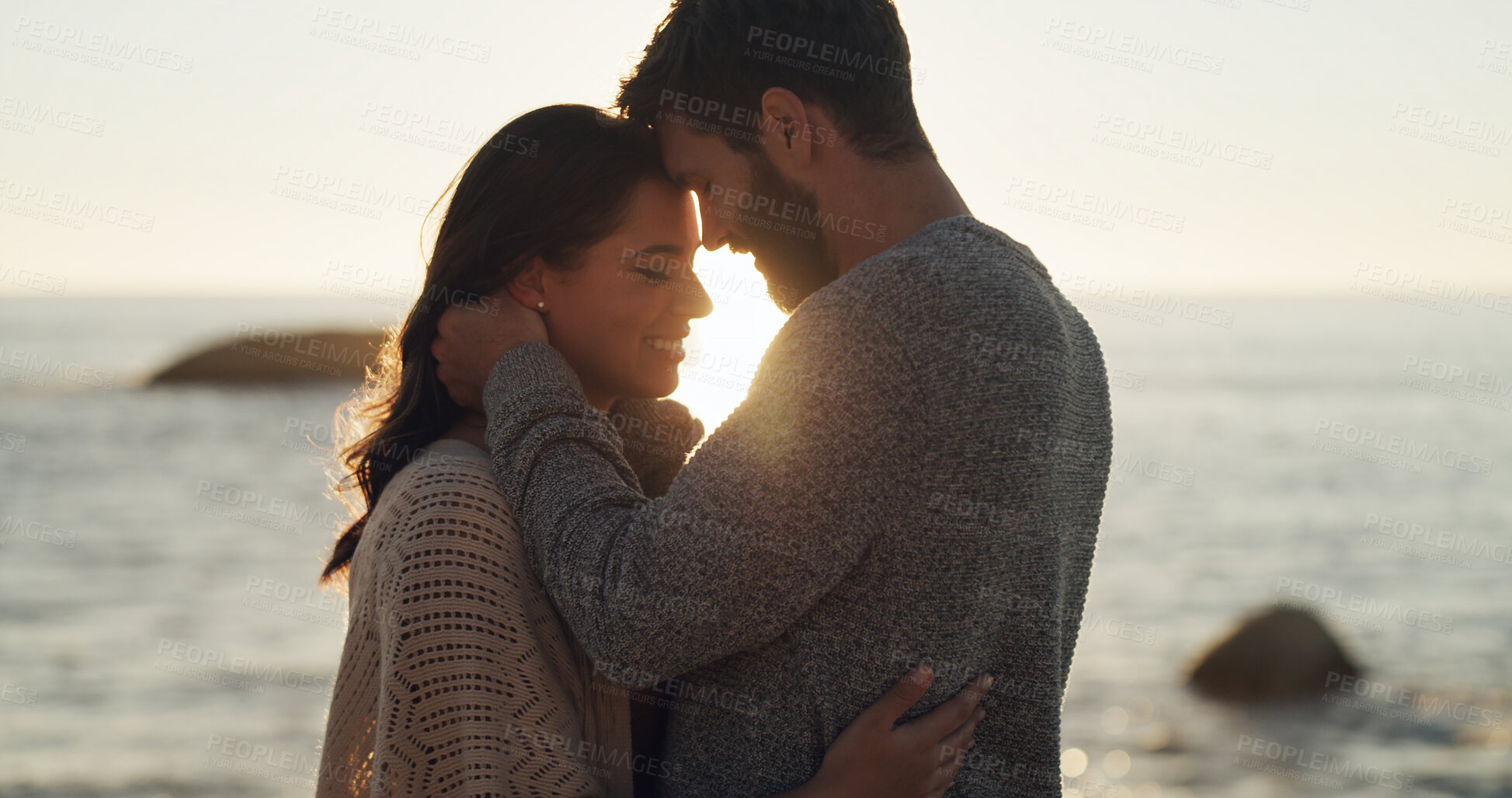 Buy stock photo Couple, smile and love with sunset on beach for summer vacation, romantic date and bonding. Happy, man and woman with travel, tropical holiday and affection for relationship and commitment at ocean