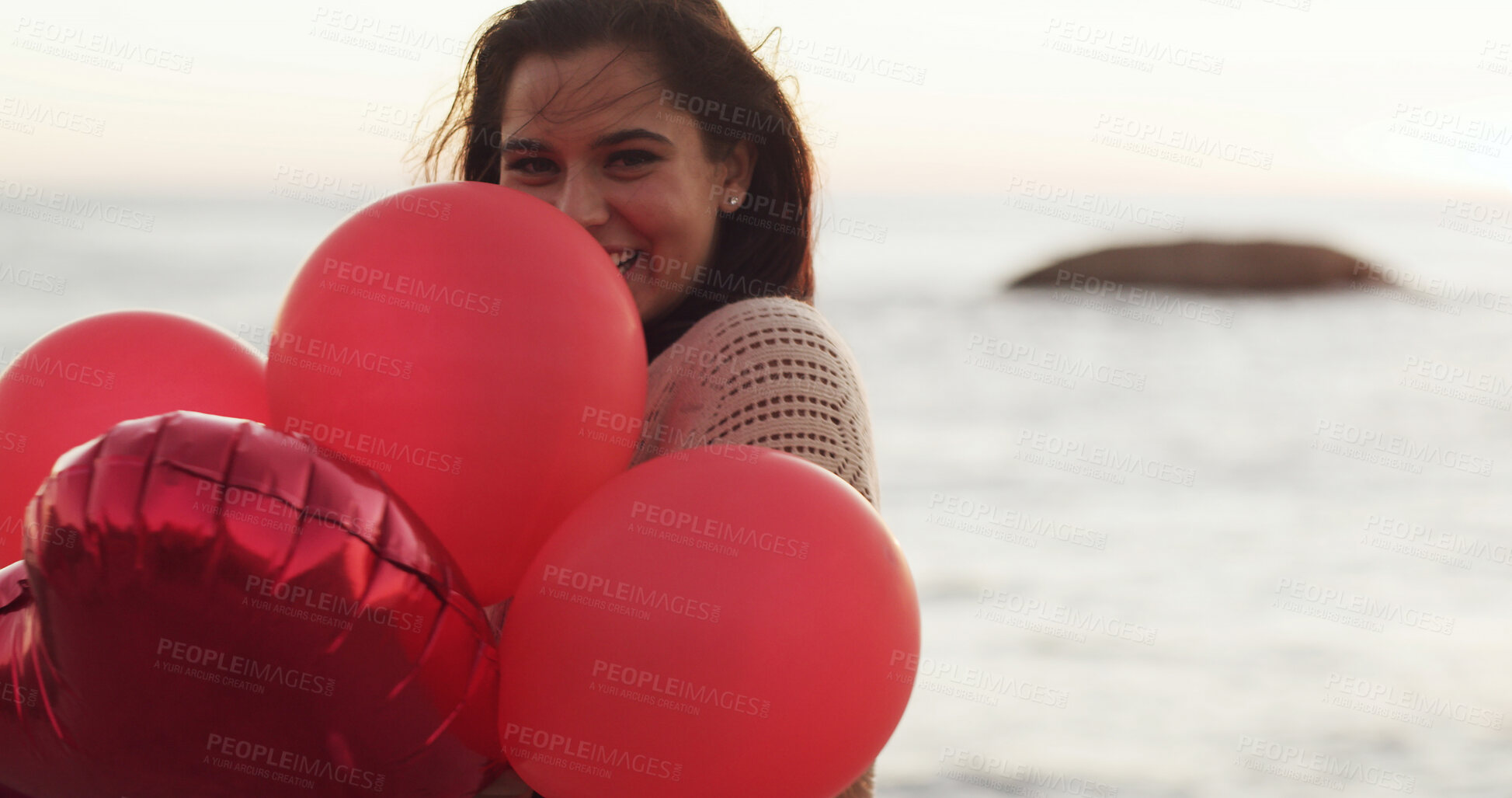 Buy stock photo Beach, celebrate and happy woman with balloons for love, present and romantic gesture. Red color, smile and female person at sea with inflatable gift for space, care and portrait on valentines day