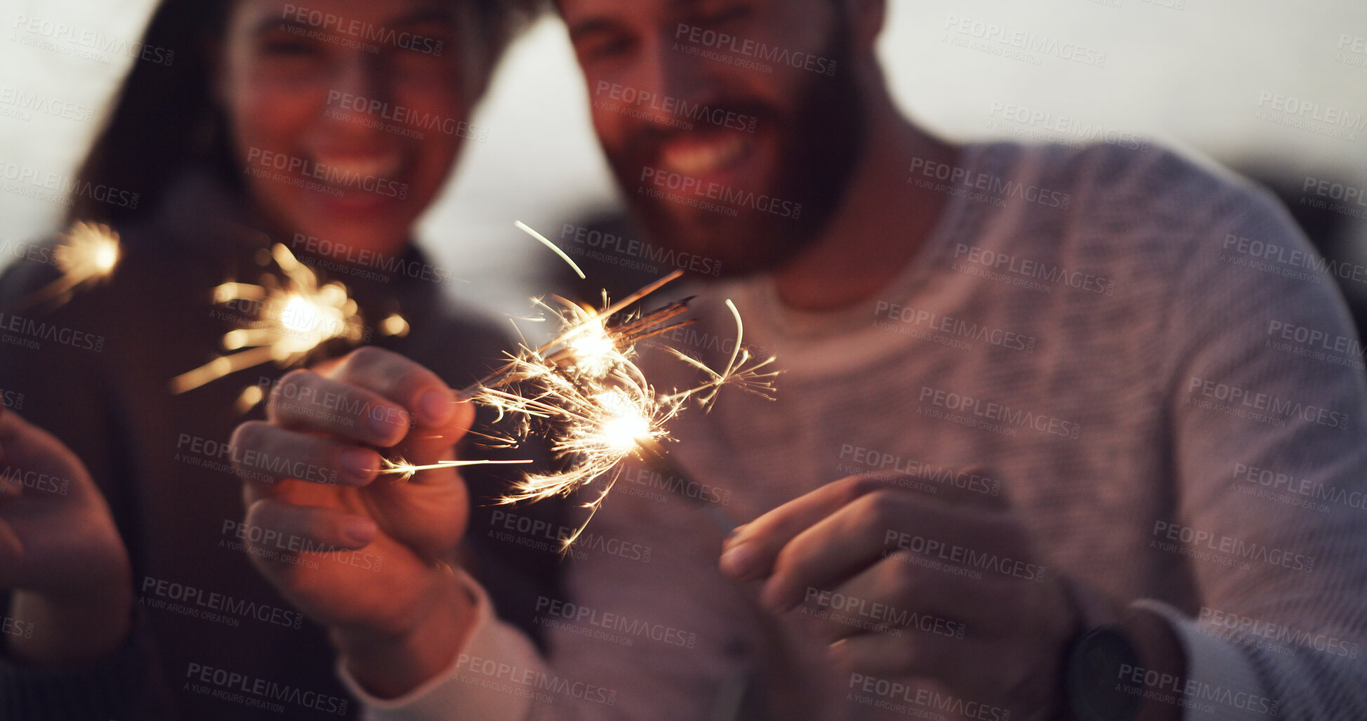 Buy stock photo Hands, sparkler and couple at night, outdoor and celebration with love, anniversary or birthday. People, fireworks and excited with bonding, party and holiday at twilight for new years eve in Spain