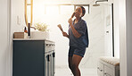 Black woman, brush and singing in bathroom, happy and performance with morning routine at home. African person, reflection and mirror with voice, dance and hair care for grooming with music at house
