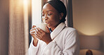 Coffee, thinking and black woman by window in home for relax, calm or peaceful morning on weekend. Happy, memory and African female person drinking cappuccino with reflection for break in house.