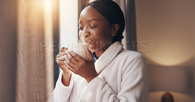 Buy stock photo Coffee, thinking and black woman by window in home for relax, calm or peaceful morning on weekend. Happy, memory and African female person drinking cappuccino with reflection for break in house.