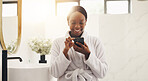 Black woman, phone and smile with texting in bathroom, scroll and chat for contact with morning routine. African person, smartphone and laugh with mobile app, meme or video on social network at home