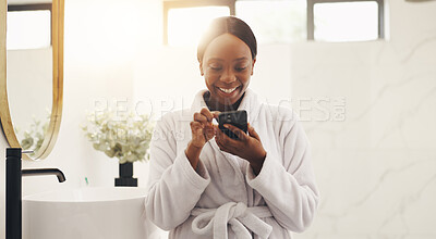 Buy stock photo Black woman, phone and smile with texting in bathroom, scroll and chat for contact with morning routine. African person, smartphone and laugh with mobile app, meme or video on social network at home