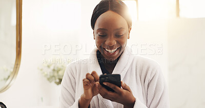Buy stock photo Black woman, phone and happy with texting in bathroom, scroll and contact with web chat in morning. African person, smartphone and smile with mobile app, funny meme or video on social media at home