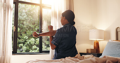 Buy stock photo Back, black woman and stretching in bedroom at house for wake up, start day and muscle relief. Female person, relax and warm up arms with blood circulation, body awareness and good sleep for wellness