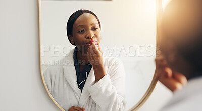 Buy stock photo Mirror, beauty and woman with lipstick, home or makeup in morning, process or moisturizer for mouth. Reflection, grooming and black person with lip gloss, self care and cosmetics in bathroom at house