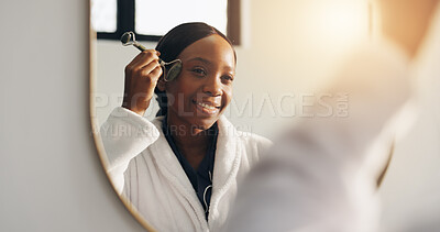 Buy stock photo Home, face roller and black woman in bathroom, reflection and skincare with grooming. Mirror, jade cosmetic tools and African person with facial massage, dermatology and beauty with wellness or smile