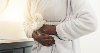 Buy stock photo Cramps, hands and woman with stomach pain in house for menstruation, bloating and PMS symptoms. Morning, person and belly ache from ovulation cycle, endometriosis inflammation and abdominal problem