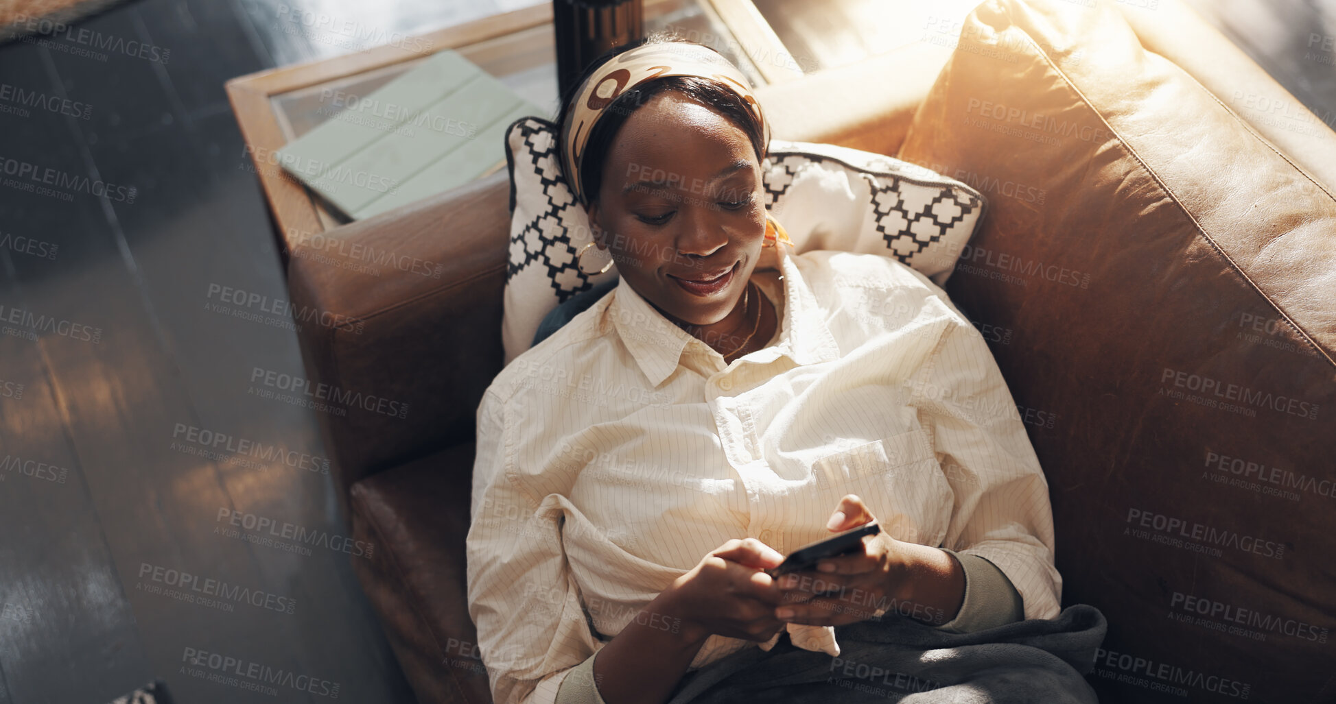 Buy stock photo Black woman, smile and relax with phone on sofa for social media browsing, online news and streaming. Above, comfortable and person with smartphone in home for app download, scrolling and dating site