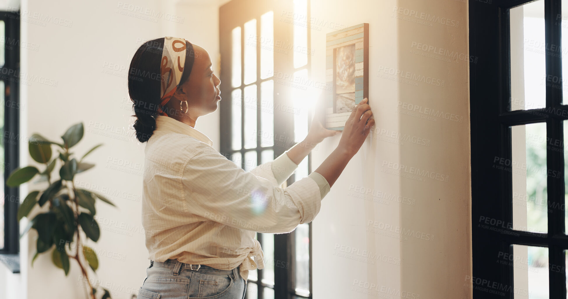 Buy stock photo Art, woman and frame on wall in home for lounge decoration, interior design and aesthetic. Apartment, black person and hang picture in living room to display memory, creative remodeling and makeover