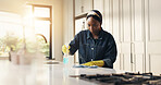 African woman, cloth and cleaning at house with detergent, sanitizing counter and remover dirt. Female person, bottle and wipe table for housekeeping, prevent bacteria and liquid for hygiene safety