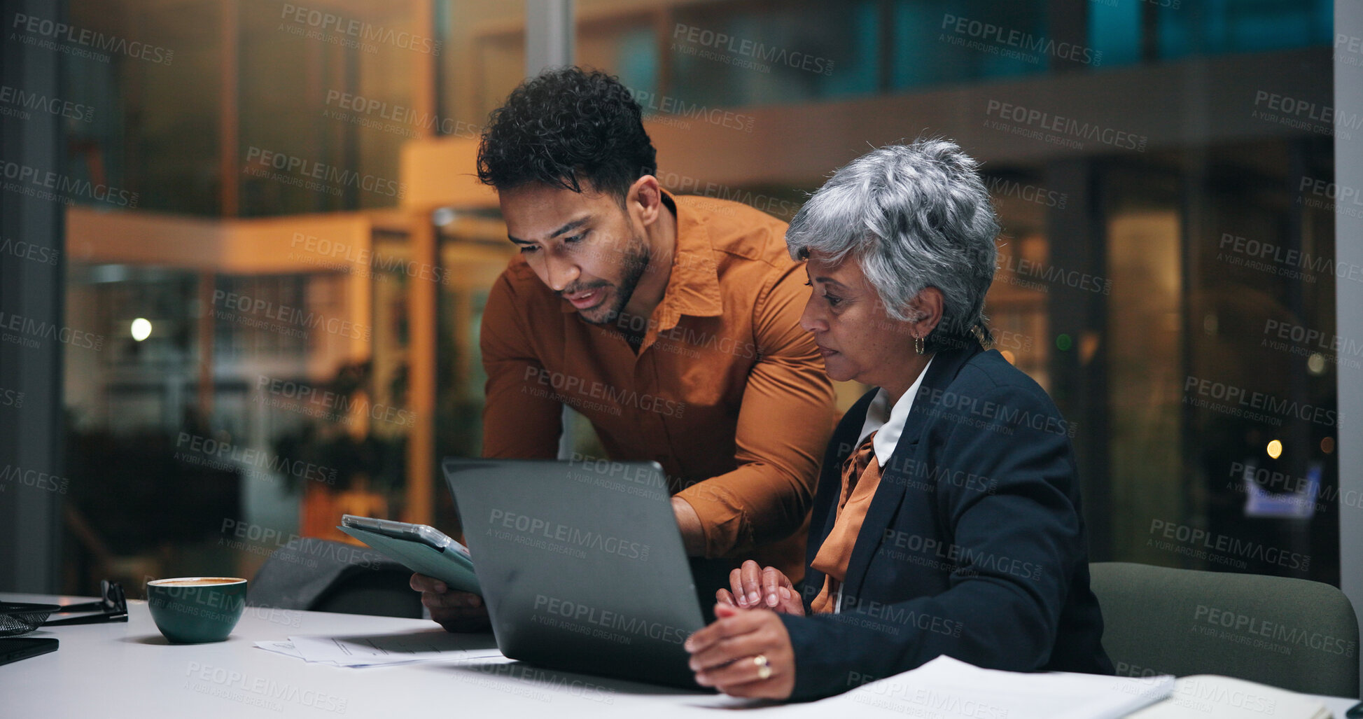 Buy stock photo Office, manager and man with tablet, night and review of campaign performance, website and teamwork. Talking, employee and asking for feedback, market research and mature woman with tech in business