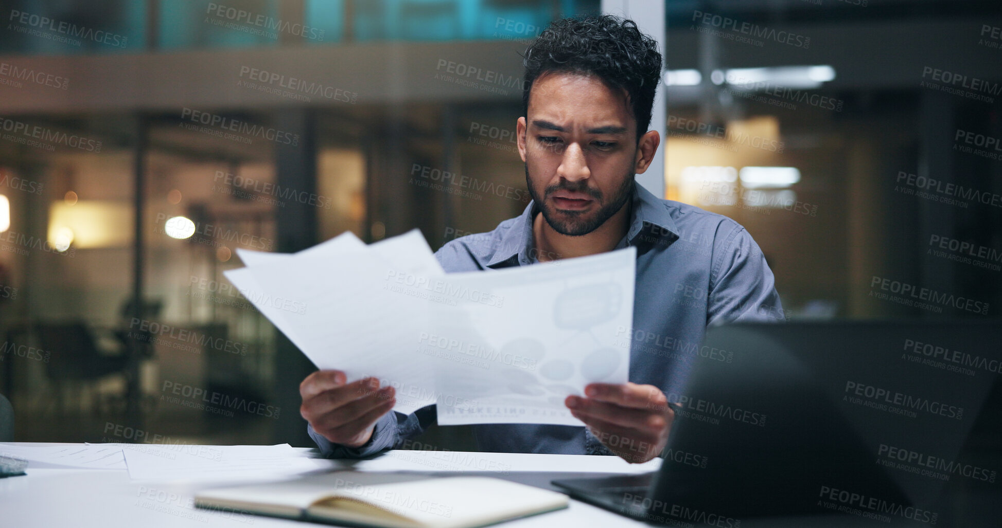 Buy stock photo Business, man or serious with paperwork in office for financial review, invoices or compliance risk. Bookkeeper, worried person and laptop with statements for budget forecasting, bankruptcy and night