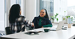 Collaboration, smile and handshake with business women in office for feedback, review or report. Laptop, teamwork and paperwork with employee shaking hands with design document, project and planning