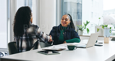 Buy stock photo Collaboration, smile and handshake with business women in office for feedback, review or report. Laptop, teamwork and paperwork with employee shaking hands with design document, project and planning