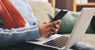 Buy stock photo Phone, laptop and hands of woman on sofa with networking, communication or mobile app in home. Computer, technology and female person with cellphone for online contact in living room at apartment.